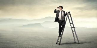 businessman-ladder-using-binoculars-desert