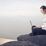 businesswoman-sitting-on-rock