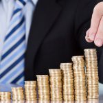 dca-businessman-coins-stack